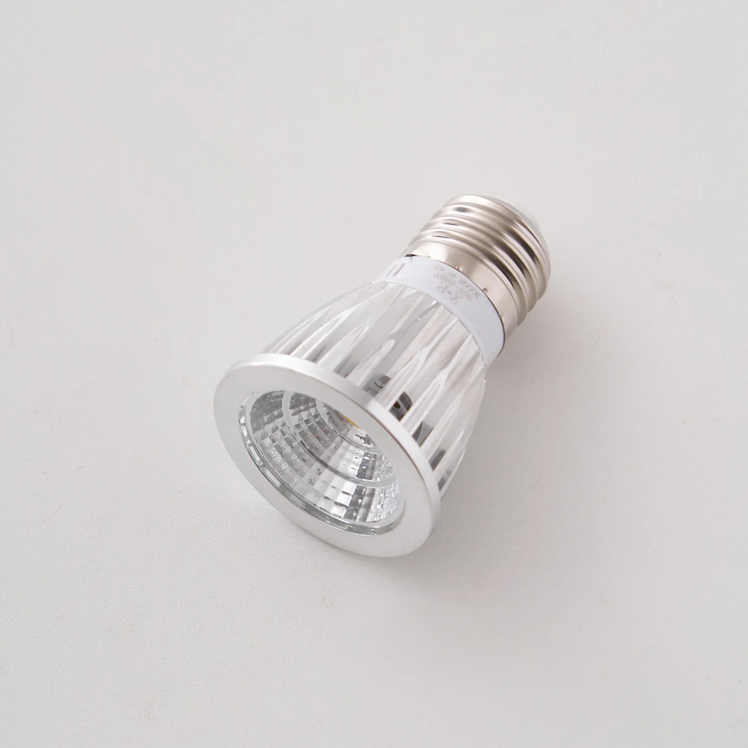 Silver LED light bulb on a white background
